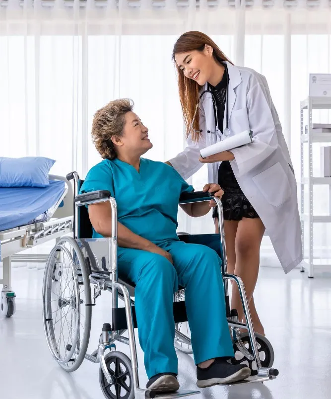A caregiver helping a patient in a wheelchair