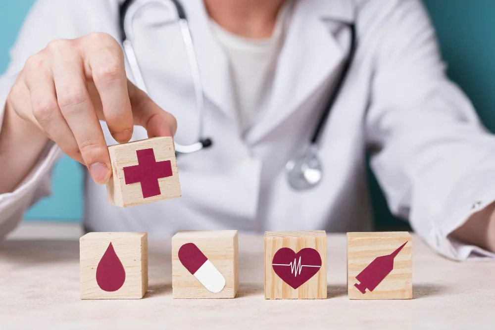 A doctor arranging wooden blocks with health icons