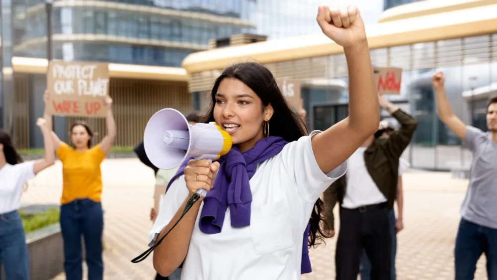 A volunteer with a megaphone at an awareness drive