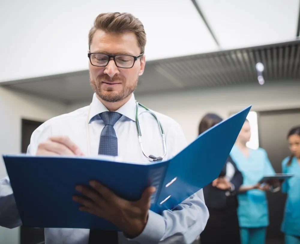 A doctor reading a medical report