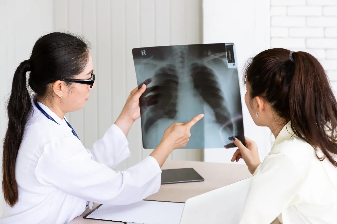 A doctor explaining a chest X-ray to a patient